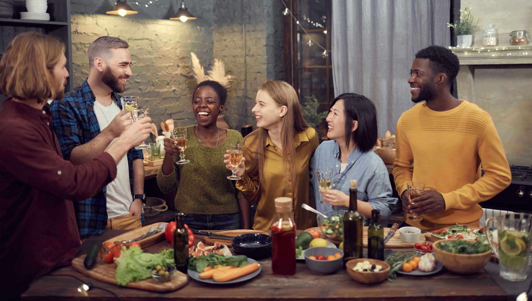 Friends conversing and laughing while eating together